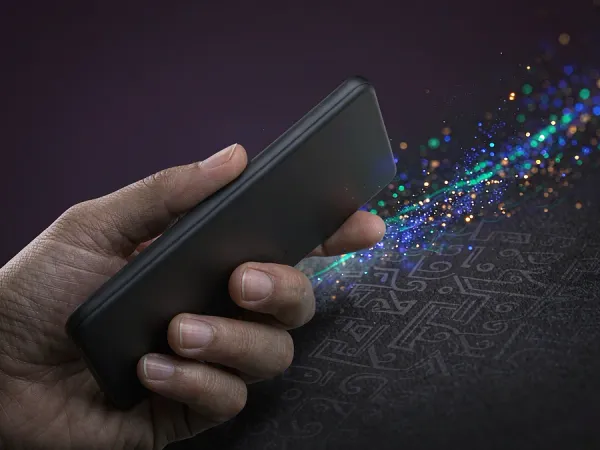 eg777 + Hand holding a smartphone with colourful light particles